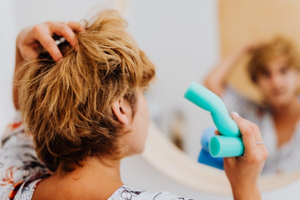 woman putting curlers in her hair