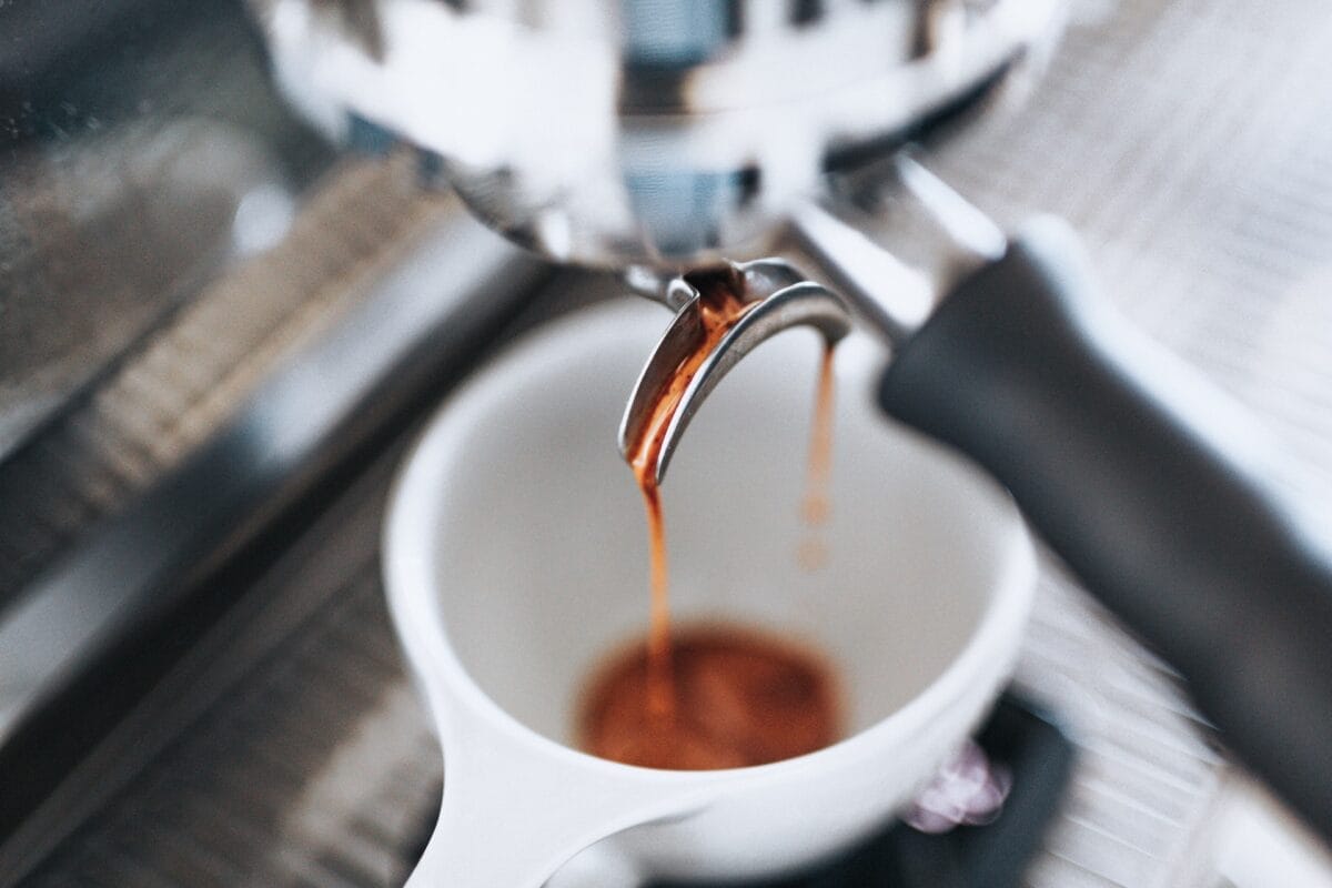 Close up of coffee pouring in cup photo